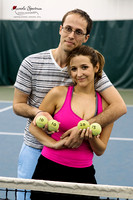 Couple holds tennis ball with their wedding date.