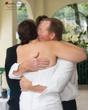 Bride hugs father at the wedding ceremony in Lake Lure, NC