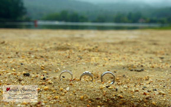 Wedding rings on beach of Lake Lure, NC