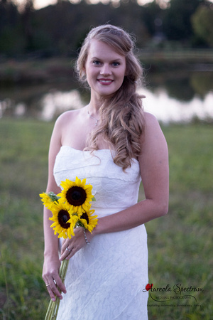 Happy bride posed in field in Monroe, NC