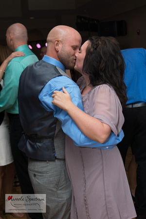 Wedding guests kiss on dance floor