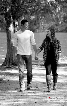 couple strolls on path at lake lure