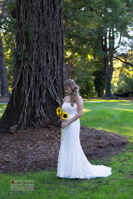 Beautiful bride with her sunflower bouquet in Monroe, NC.