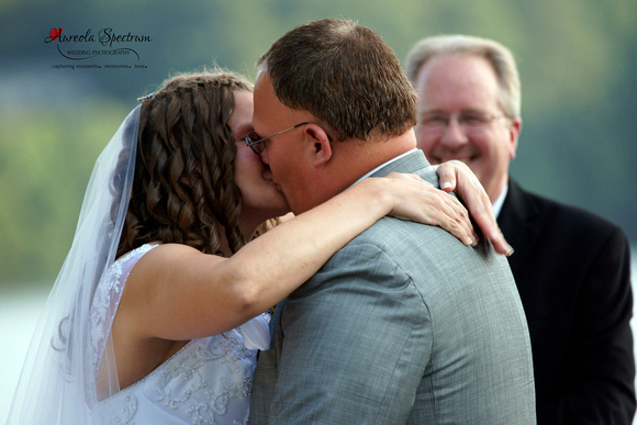 Bride and groom kiss at lake wheeler wedding ceremony