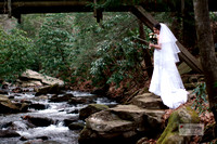 beautiful bride standing beside a roaring river