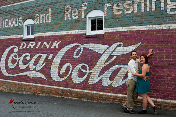 Striking engagement couple in front of 50s mural.