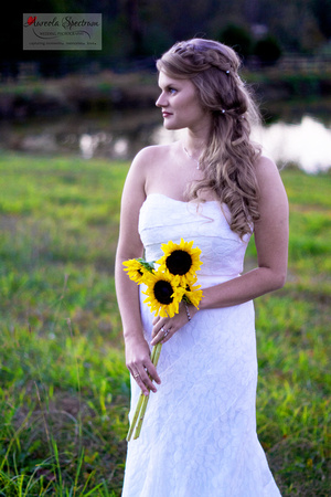 Bride holds sunflowers in Monroe, NC field