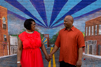 Engaged couple posed in front of NODA mural