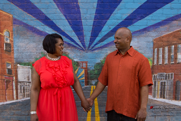 Engaged couple posed in front of NODA mural