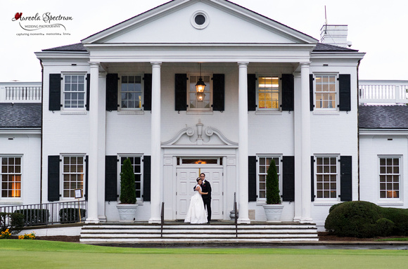 Traditional bride and groom pose in front of country club in Greensboro, NC.