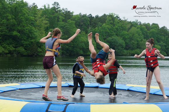 Heart kids jump on the water trampoline at camp luck.