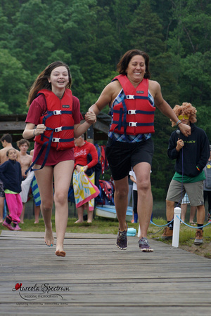 Pair runs down dock at Camp Luck Family Camp.