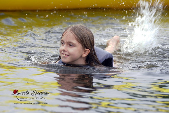 Heart kid swims in the water at camp luck family camp 2016.