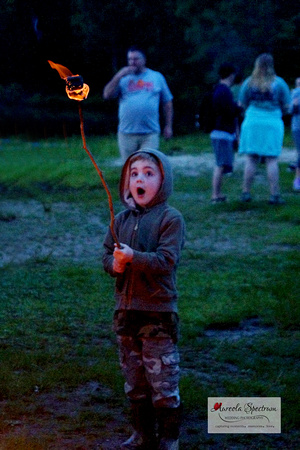 Cute kid roasting marshmallows at Camp Luck 2016.
