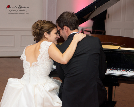 Candid moment between Bride and Groom as he plays the piano at their Greensboro, NC wedding.