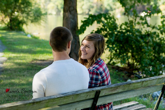 Couple laughs on bench in Lake Lure, NC