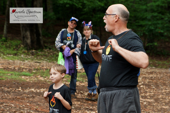 Camp director leads song at camp luck family camp.