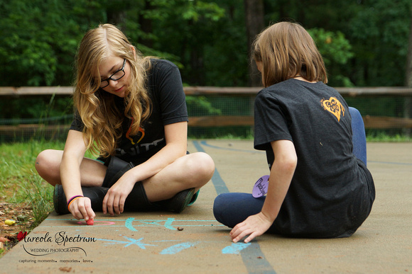 Heart kids playing tic tac toe at camp luck.