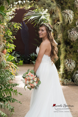 Bride smiles inside cacti tunnel.